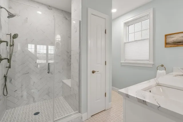 a bathroom with a sink a shower and a mirror
