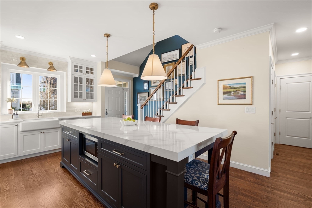 22 Sunset Way, Unit 22 Medfield, MA 02052 - Photo 6 of 42 a kitchen with sink cabinets and wooden floor