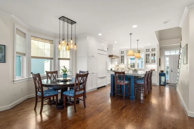 a dining room with furniture window and wooden floor
