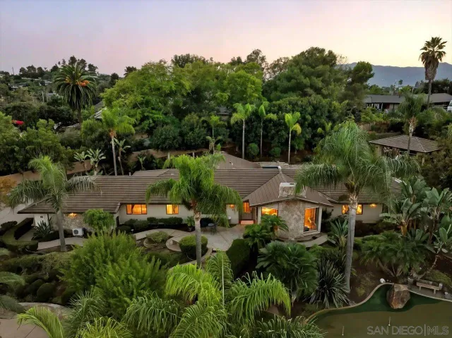 a view of house with backyard outdoor seating and green space