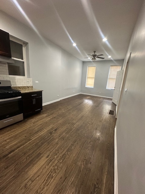2829 West Polk Street, Unit 1 Chicago, IL 60612 - Photo 4 of 6 an empty room with wooden floor and windows