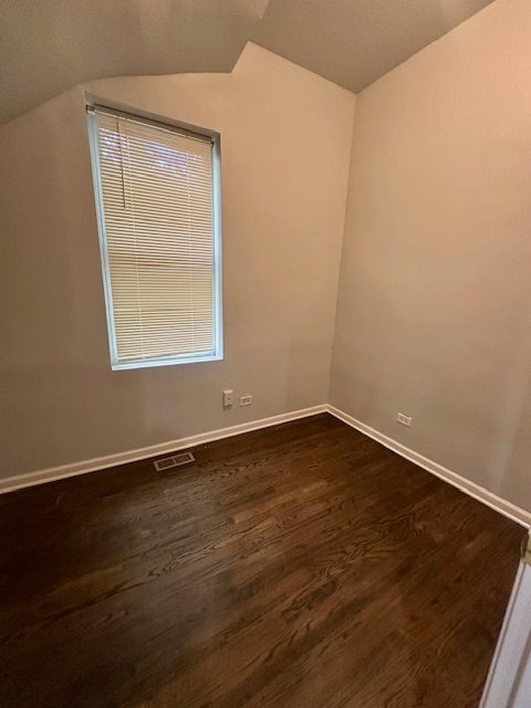 2829 West Polk Street, Unit 1 Chicago, IL 60612 - Photo 6 of 6 an empty room with wooden floor and windows