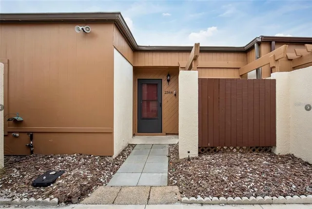 a view of a house with a wooden fence