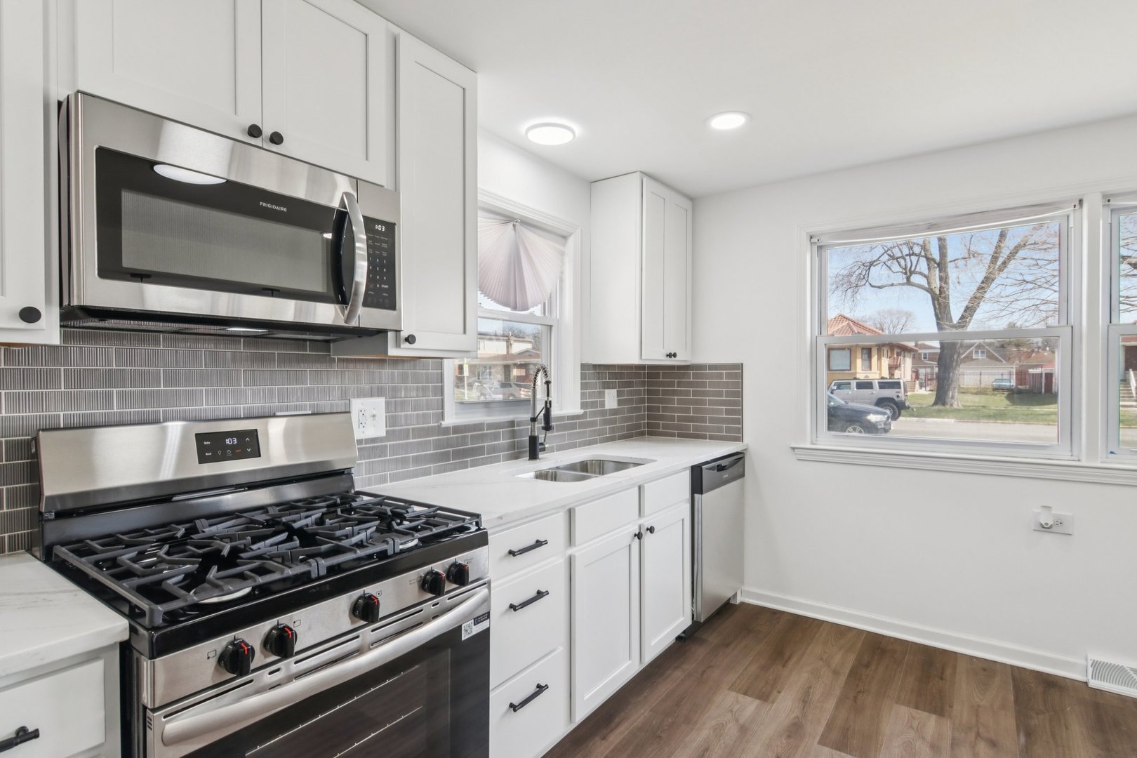8630 South Indiana Avenue Chicago, IL 60619 - Photo 11 of 33 a kitchen with stainless steel appliances a stove microwave and sink