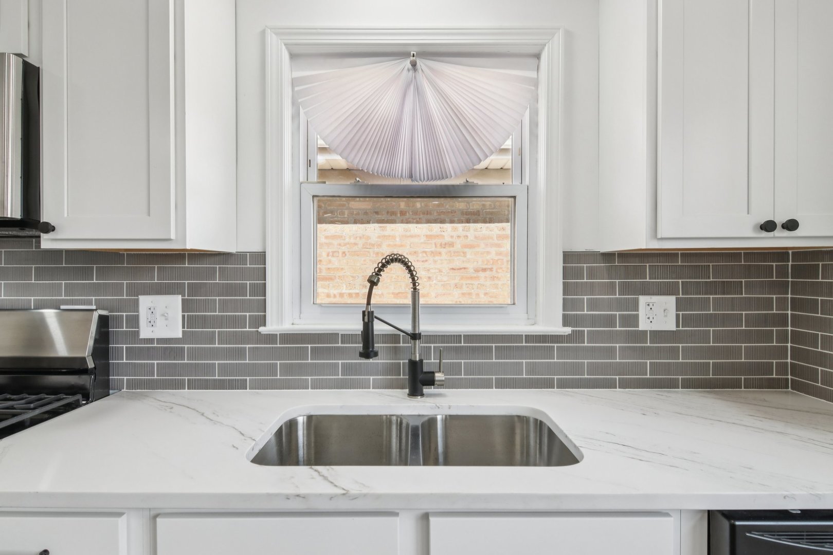 8630 South Indiana Avenue Chicago, IL 60619 - Photo 12 of 33 a kitchen with granite countertop a sink and a window