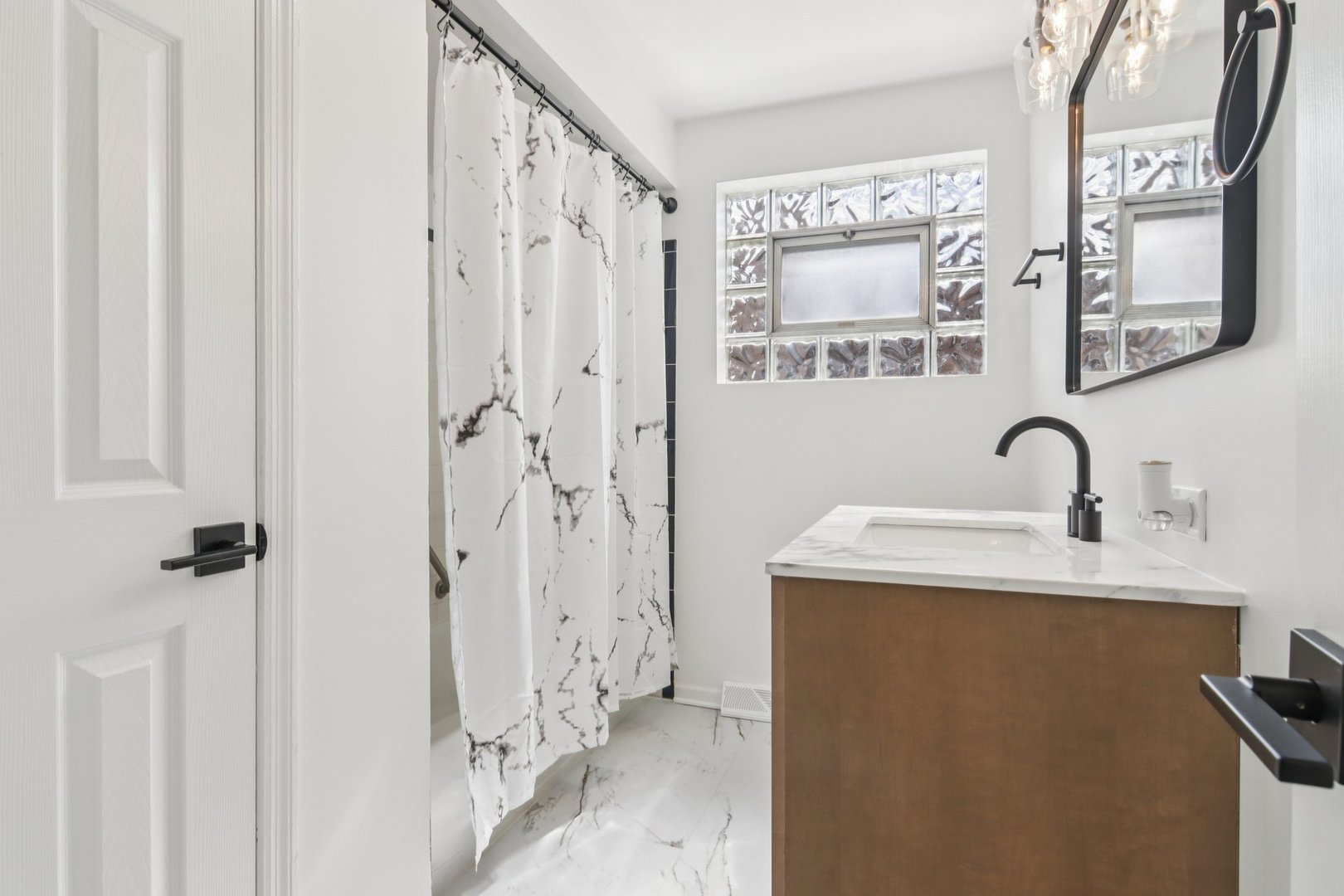 8630 South Indiana Avenue Chicago, IL 60619 - Photo 14 of 33 a bathroom with a sink and a mirror