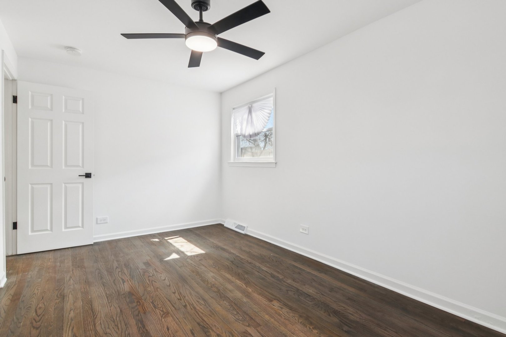 8630 South Indiana Avenue Chicago, IL 60619 - Photo 15 of 33 an empty room with wooden floor and windows