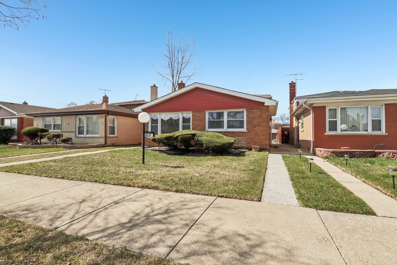 8630 South Indiana Avenue Chicago, IL 60619 - Photo 2 of 33 a front view of a house with a yard