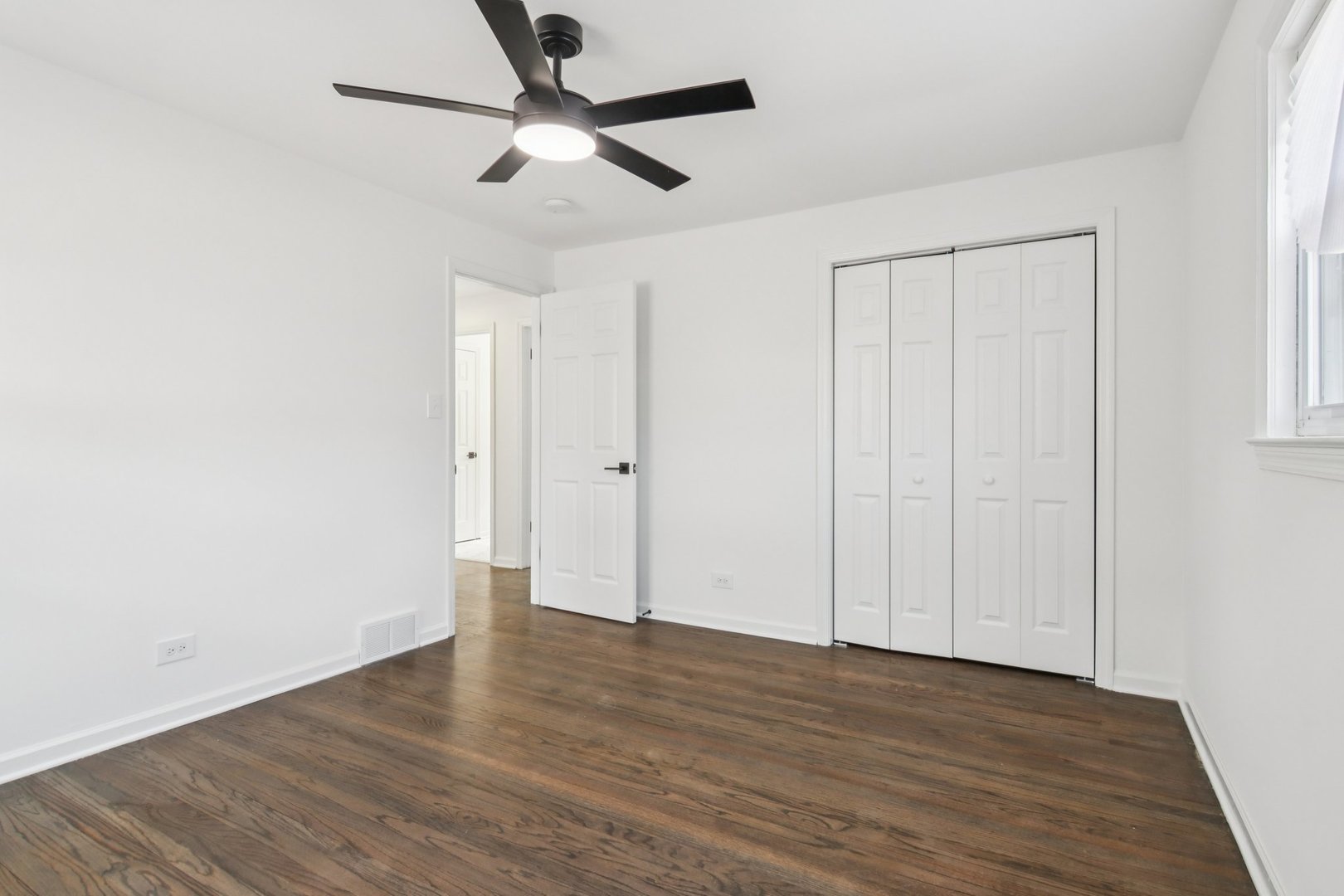 8630 South Indiana Avenue Chicago, IL 60619 - Photo 21 of 33 a view of an empty room with wooden floor