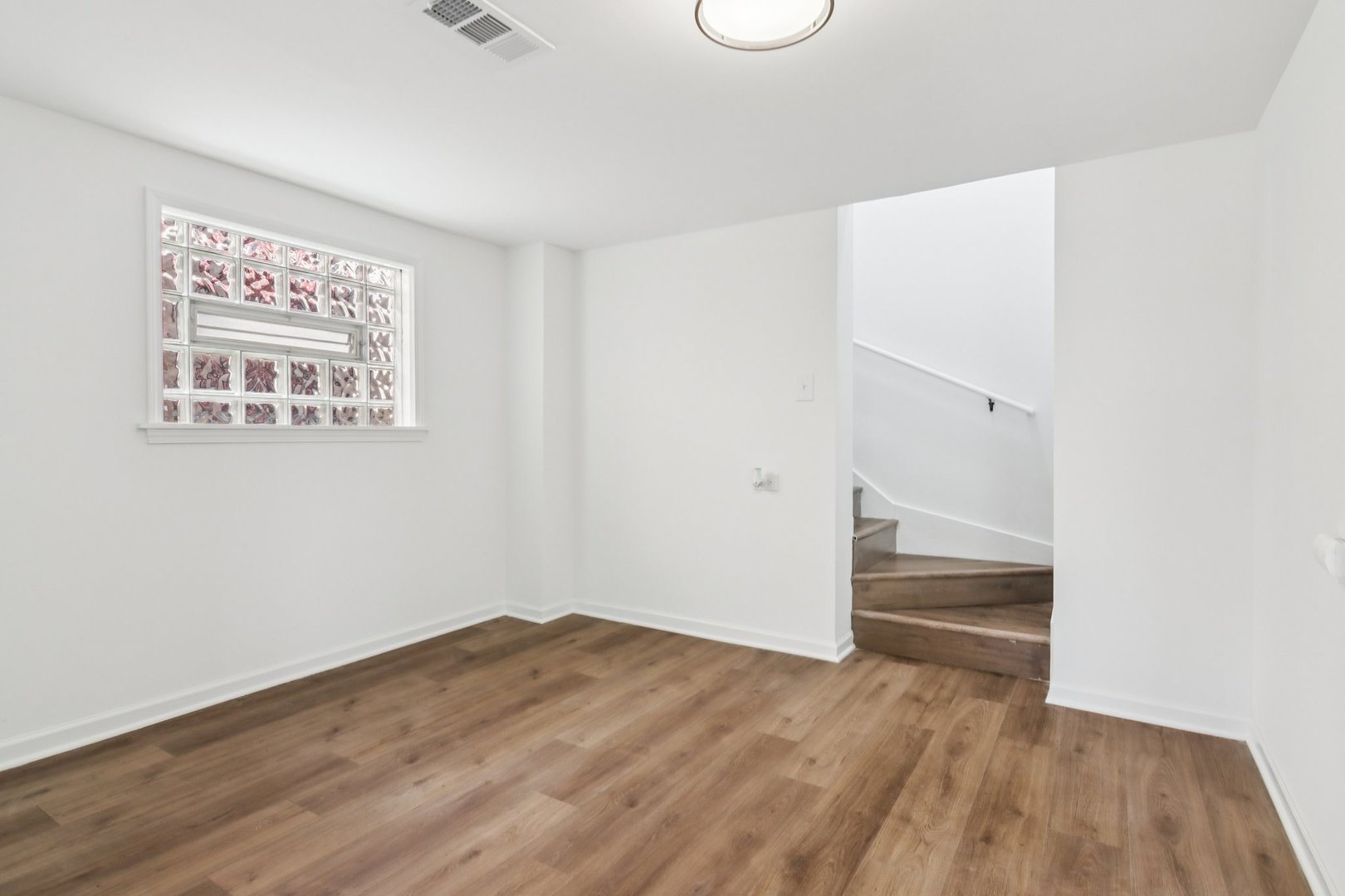 8630 South Indiana Avenue Chicago, IL 60619 - Photo 22 of 33 a view of an empty room with wooden floor