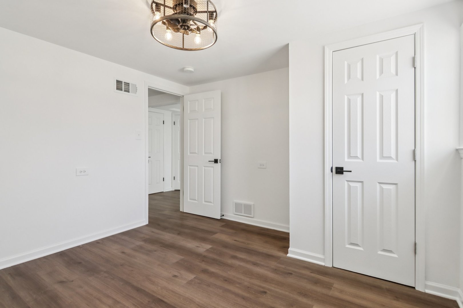 8630 South Indiana Avenue Chicago, IL 60619 - Photo 25 of 33 a view of a hallway with wooden floor