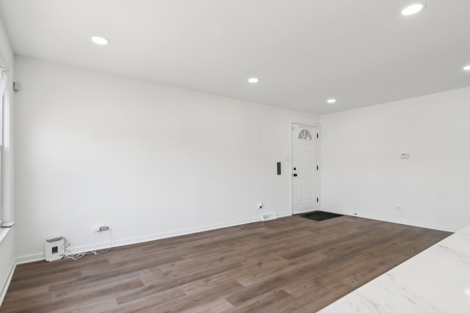 8630 South Indiana Avenue Chicago, IL 60619 - Photo 5 of 33 an empty room with wooden floor and windows