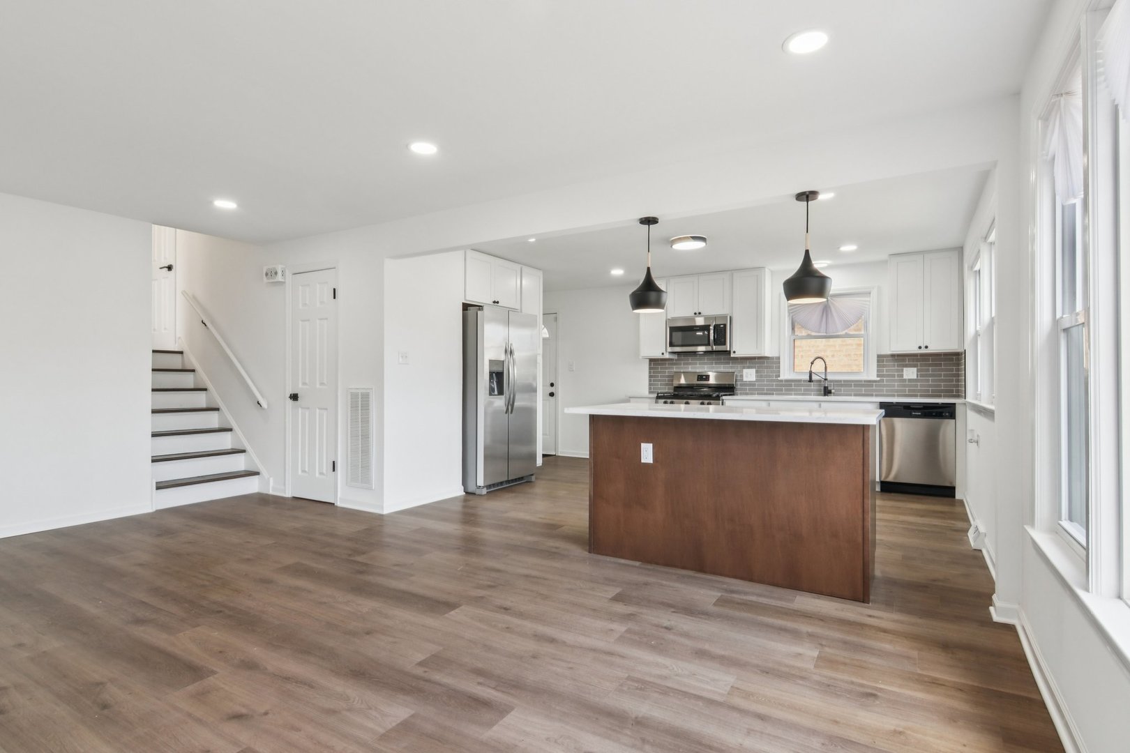 8630 South Indiana Avenue Chicago, IL 60619 - Photo 8 of 33 a large kitchen with stainless steel appliances kitchen island granite countertop a stove a sink and a refrigerator