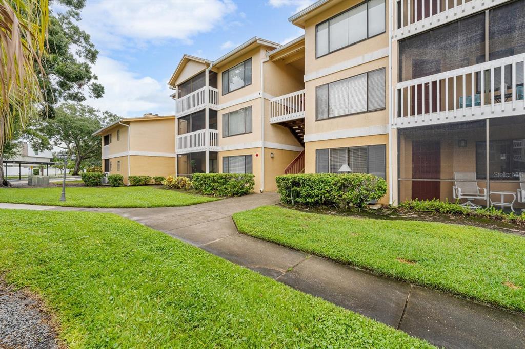 1550 South Belcher Road, Unit 223 Clearwater, FL 33764 - Photo 2 of 38 a view of a building next to a yard