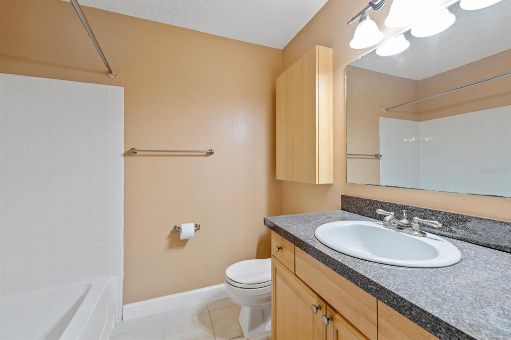 1550 South Belcher Road, Unit 223 Clearwater, FL 33764 - Photo 23 of 38 a bathroom with a granite countertop sink and a mirror