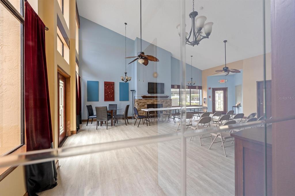 1550 South Belcher Road, Unit 223 Clearwater, FL 33764 - Photo 28 of 38 a view of a dining room and livingroom with furniture wooden floor a chandelier