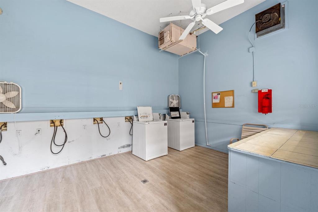 1550 South Belcher Road, Unit 223 Clearwater, FL 33764 - Photo 32 of 38 a view of a room with wooden floor and chandelier fan