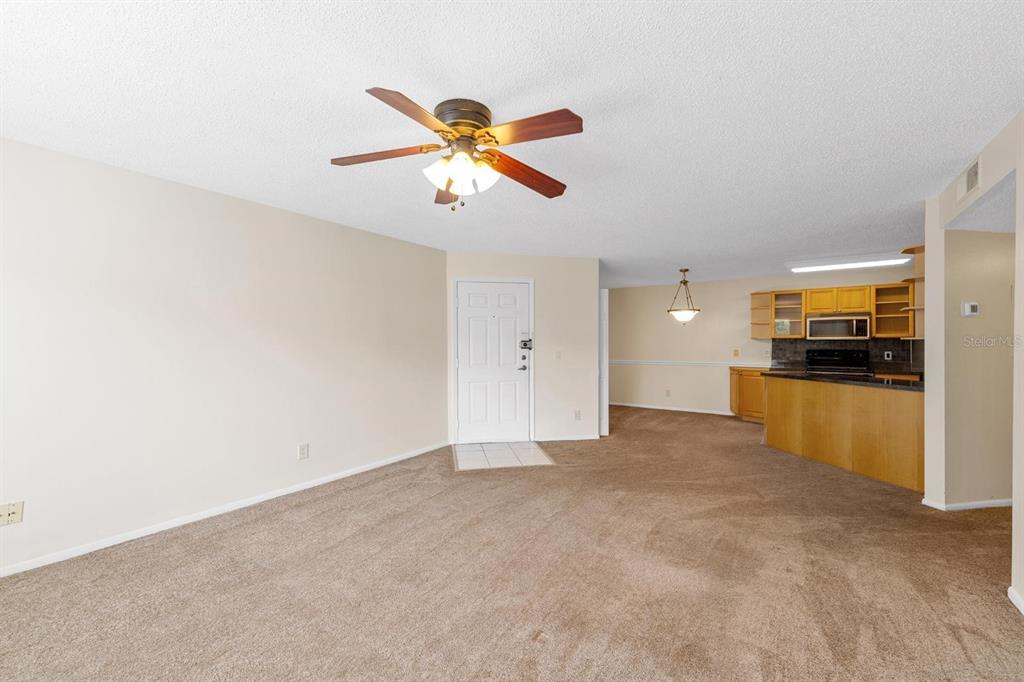 1550 South Belcher Road, Unit 223 Clearwater, FL 33764 - Photo 7 of 38 a view of an empty room with kitchen and window