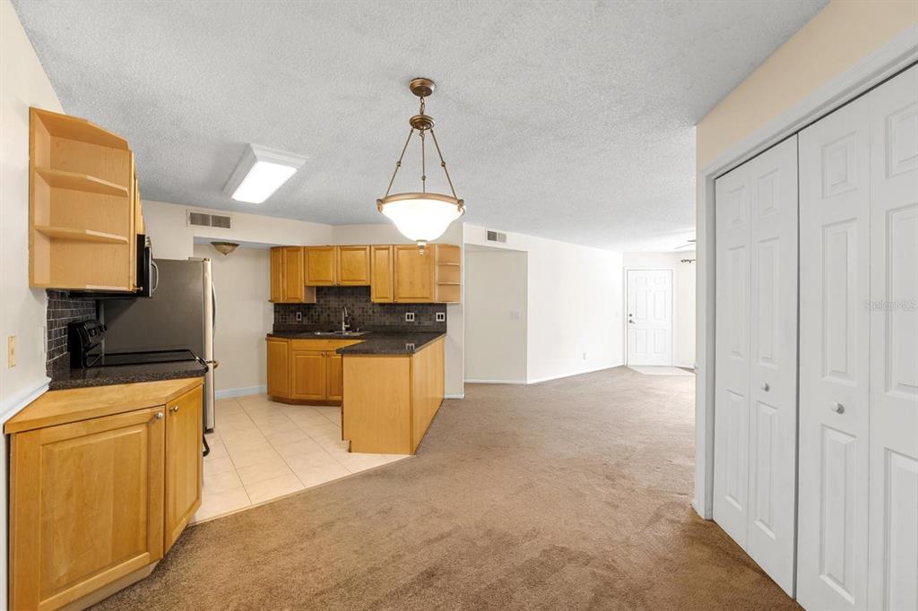 1550 South Belcher Road, Unit 223 Clearwater, FL 33764 - Photo 9 of 38 a kitchen with stainless steel appliances granite countertop a stove a sink and a refrigerator