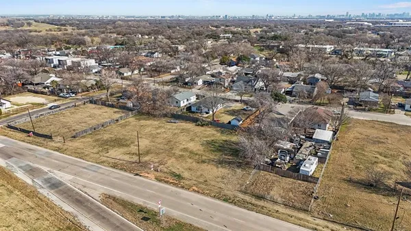 an aerial view of residential houses with city view