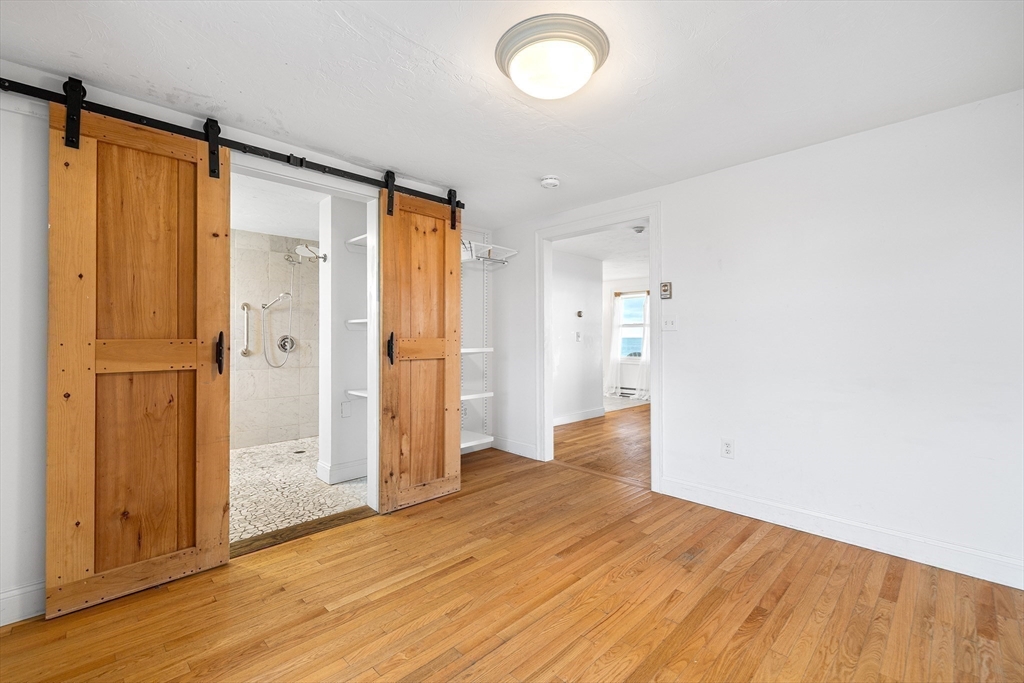 544 Shore Road, Unit 3 Truro, MA 02666 - Photo 21 of 30 a view of empty room with wooden floor and window