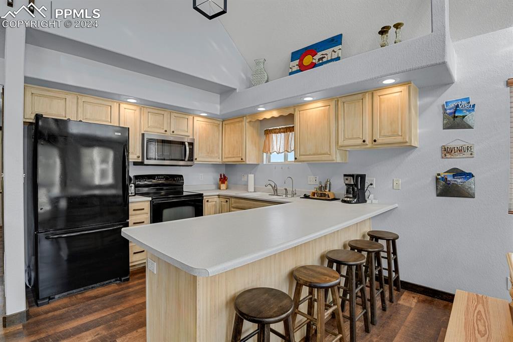 998 Bunker Hill Road Silver Cliff, CO 81252 - Photo 14 of 49 a kitchen with stainless steel appliances a microwave sink and refrigerator