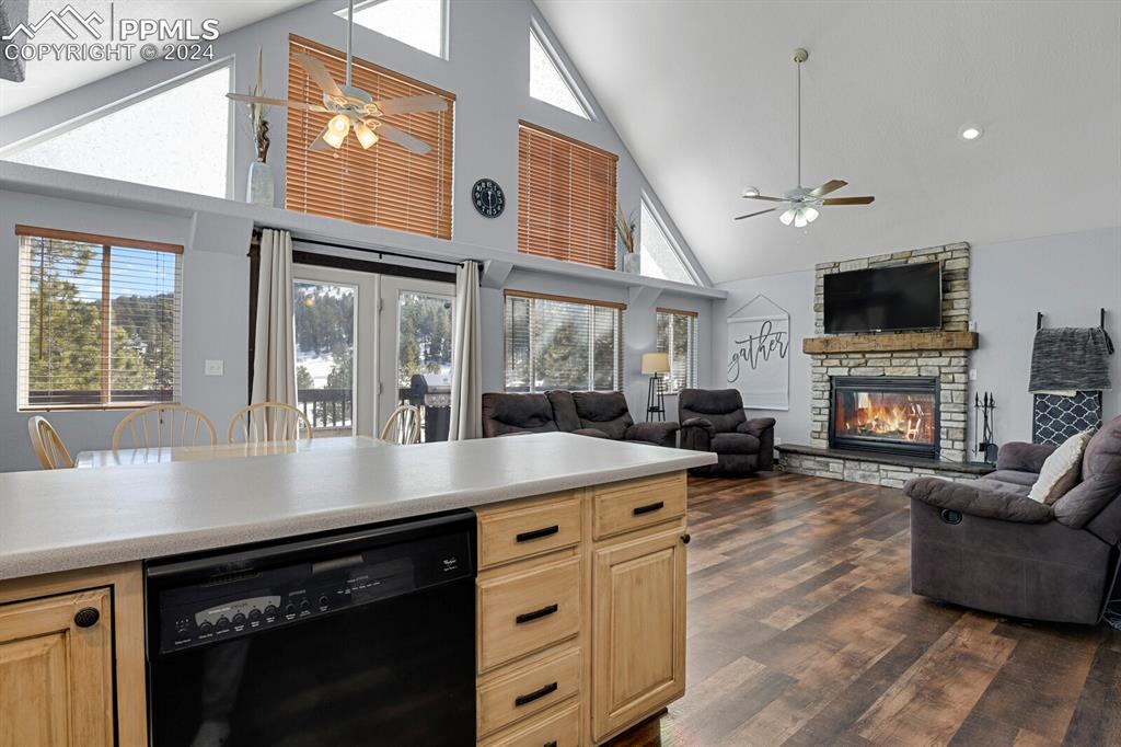 998 Bunker Hill Road Silver Cliff, CO 81252 - Photo 15 of 49 a open kitchen with furniture a fireplace and a flat screen tv