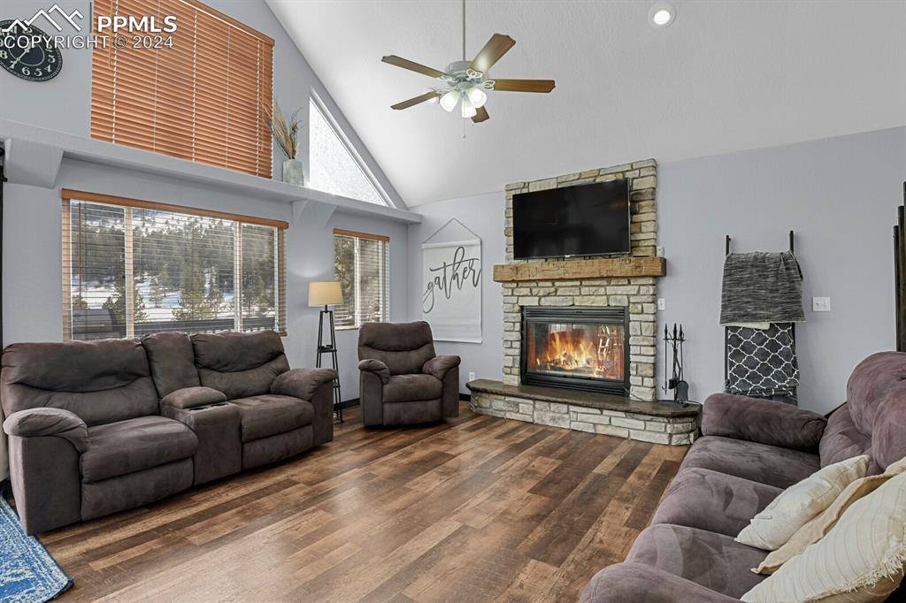 998 Bunker Hill Road Silver Cliff, CO 81252 - Photo 20 of 49 a living room with furniture a flat screen tv and a fireplace