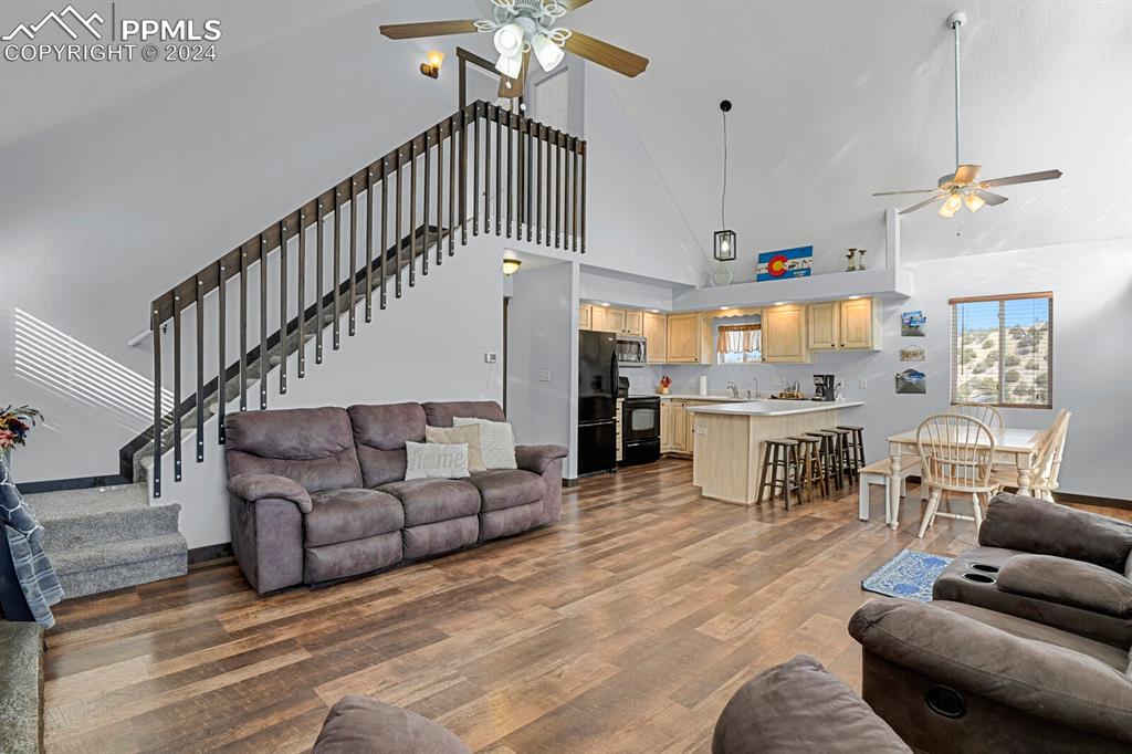 998 Bunker Hill Road Silver Cliff, CO 81252 - Photo 23 of 49 a living room with furniture kitchen view and a chandelier