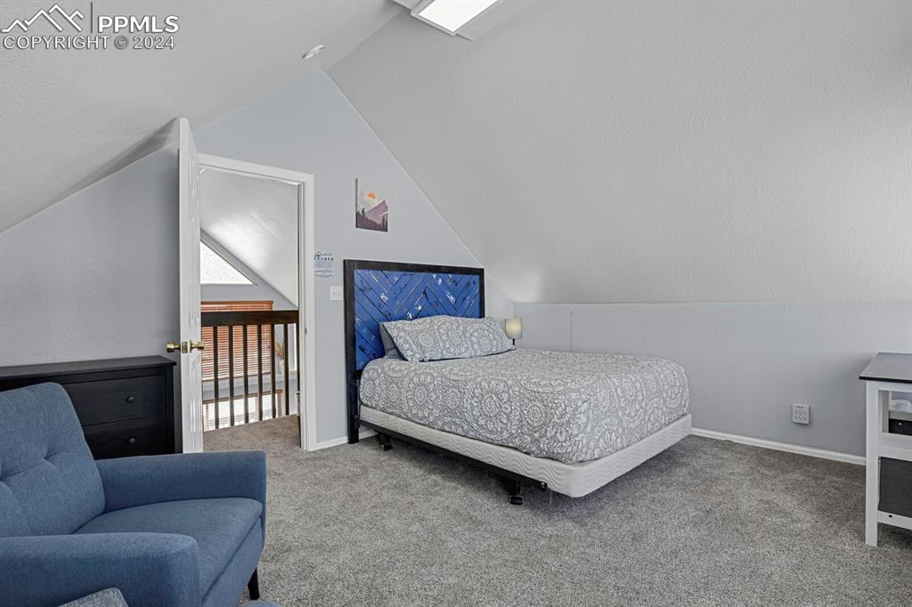 998 Bunker Hill Road Silver Cliff, CO 81252 - Photo 25 of 49 a bedroom with a bed couch and a window