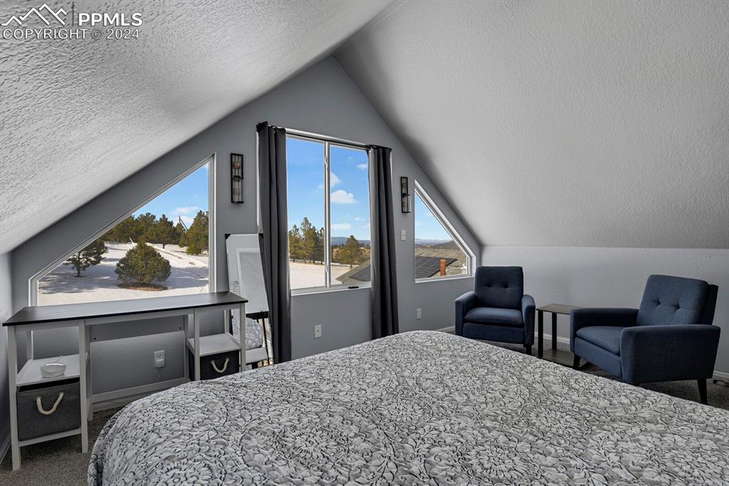 998 Bunker Hill Road Silver Cliff, CO 81252 - Photo 27 of 49 a bedroom with a bed and a dresser next to a window