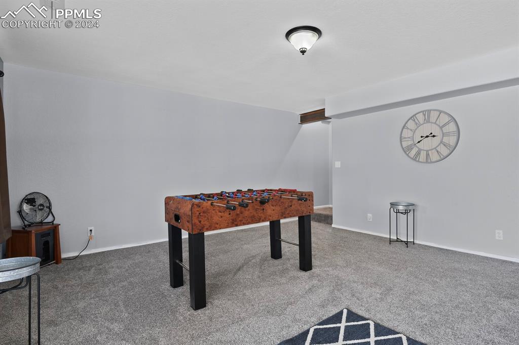 998 Bunker Hill Road Silver Cliff, CO 81252 - Photo 28 of 49 a room with a table and a clock