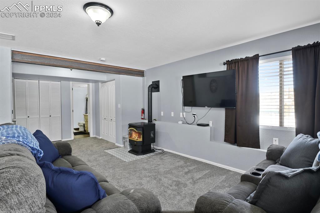 998 Bunker Hill Road Silver Cliff, CO 81252 - Photo 33 of 49 a living room with furniture and a flat screen tv