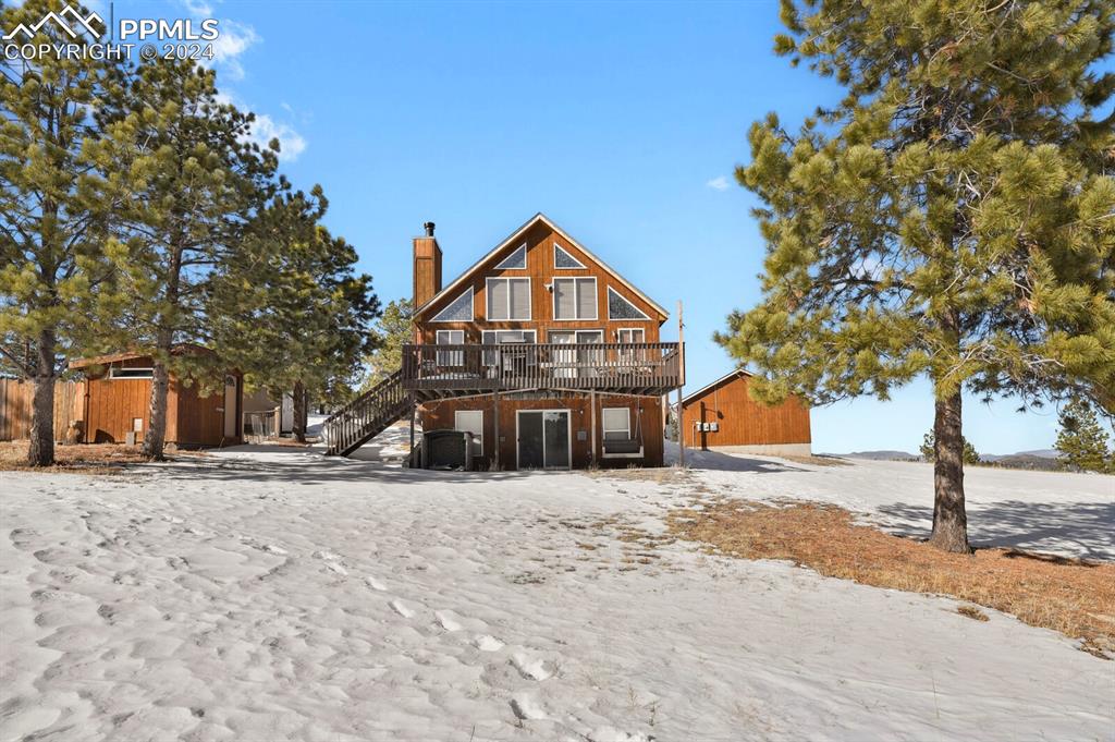 998 Bunker Hill Road Silver Cliff, CO 81252 - Photo 40 of 49 a front view of a house with a yard covered with snow and trees