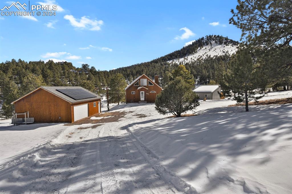 998 Bunker Hill Road Silver Cliff, CO 81252 - Photo 43 of 49 a view of a house with a snow in the background