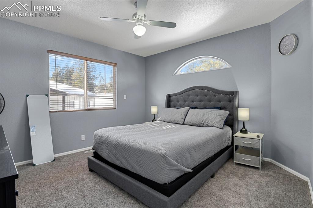 998 Bunker Hill Road Silver Cliff, CO 81252 - Photo 6 of 49 a bedroom with a bed lamp and a window