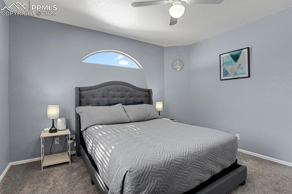 998 Bunker Hill Road Silver Cliff, CO 81252 - Photo 7 of 49 a bedroom with a bed and a lamp