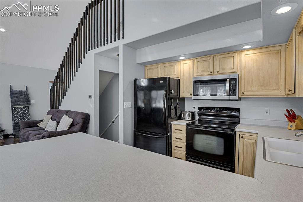 998 Bunker Hill Road Silver Cliff, CO 81252 - Photo 10 of 49 a kitchen with a refrigerator stove and microwave