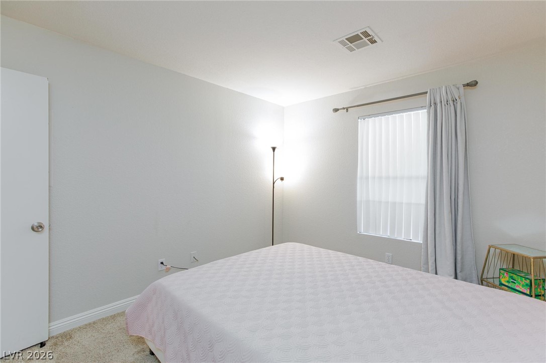 5171 South Lindell Road, Unit 103 Las Vegas, NV 89118 - Photo 15 of 24 A well-lit bedroom features ample natural illumination and soft carpet underfoot for comfort.