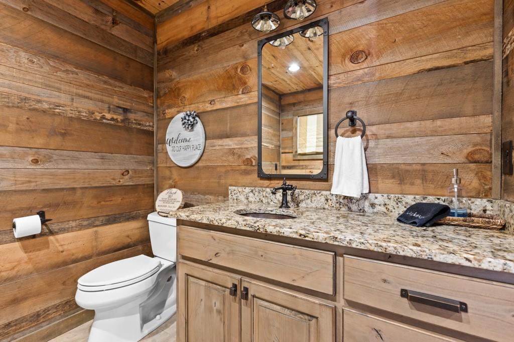 436 Geronimo Road Cherry Log, GA 30522 - Photo 23 of 58 a bathroom with a granite countertop toilet sink and mirror