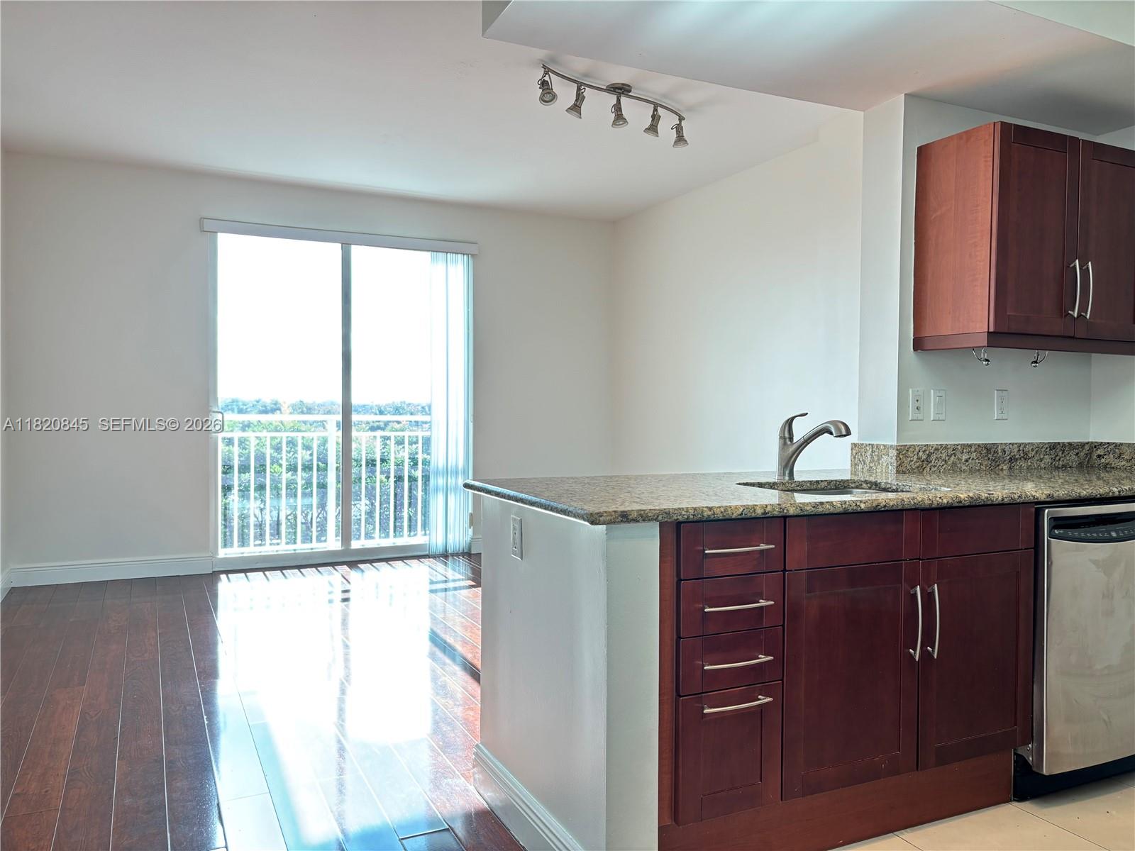7275 Southwest 90th Way, Unit 405 Miami, FL 33156 - Photo 2 of 9 a kitchen with a sink and a window