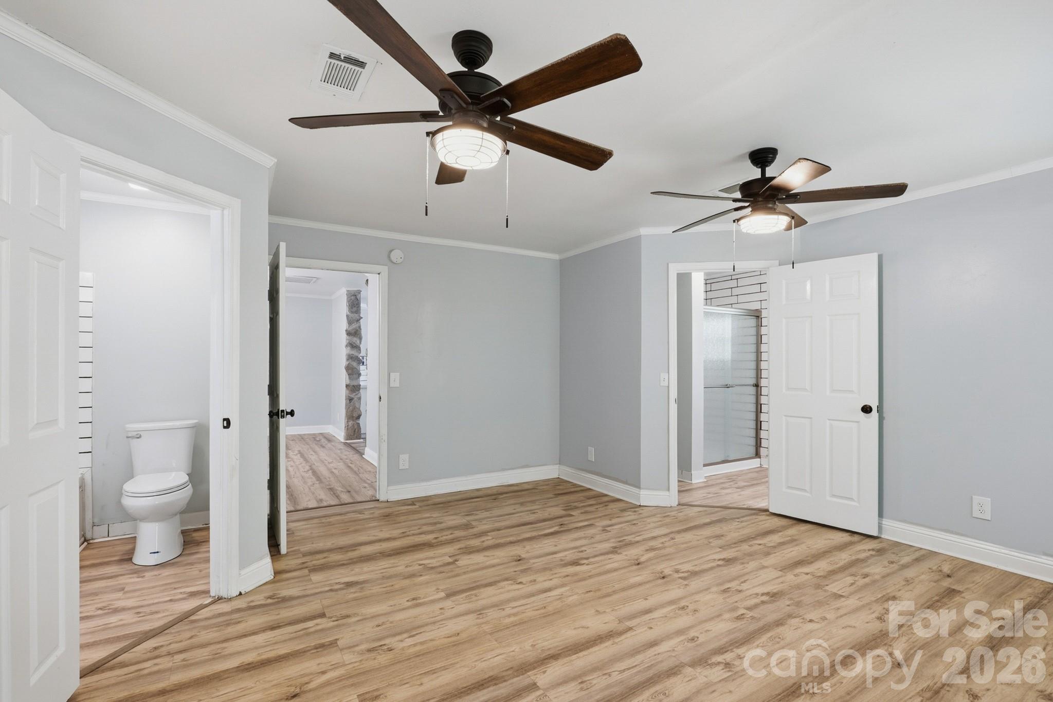 116 Springdale Drive York, SC 29745 - Photo 16 of 32 a view of a room with wooden floor and a ceiling fan