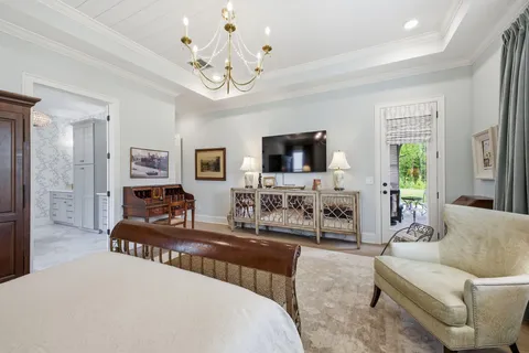 a living room with furniture a clock and a flat screen tv