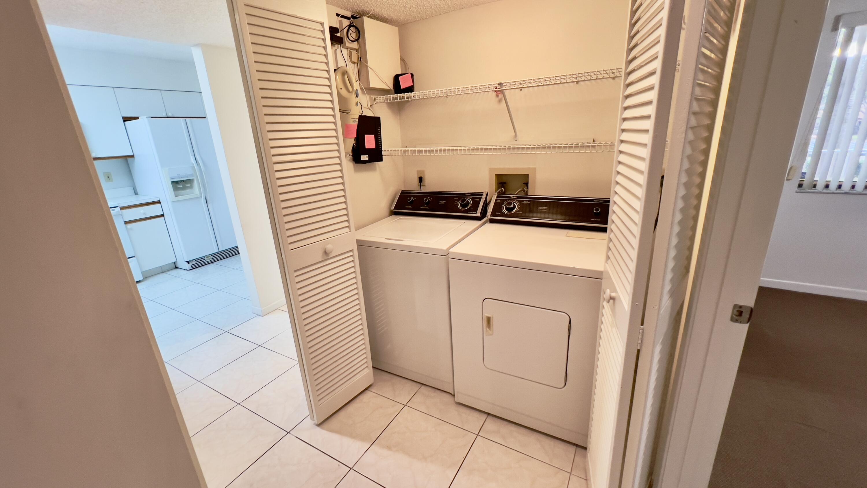 6121 Pointe Regal Circle, Unit 209 Delray Beach, FL 33484 - Photo 12 of 41 a utility room with dryer and washer