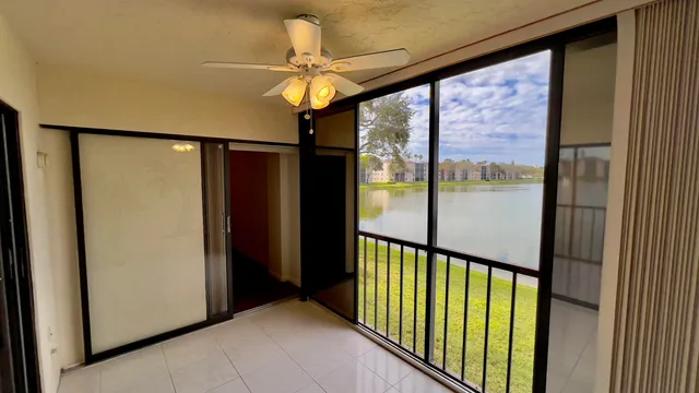 an aerial view of residential houses with outdoor space and lake view