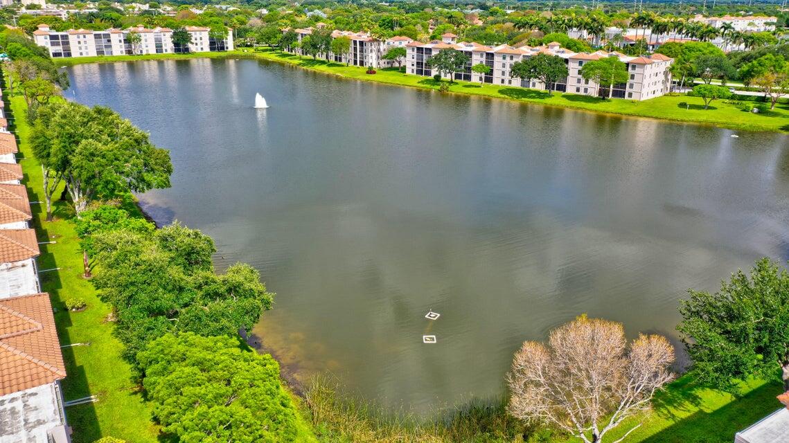 6121 Pointe Regal Circle, Unit 209 Delray Beach, FL 33484 - Photo 20 of 41 a view of a lake with a houses