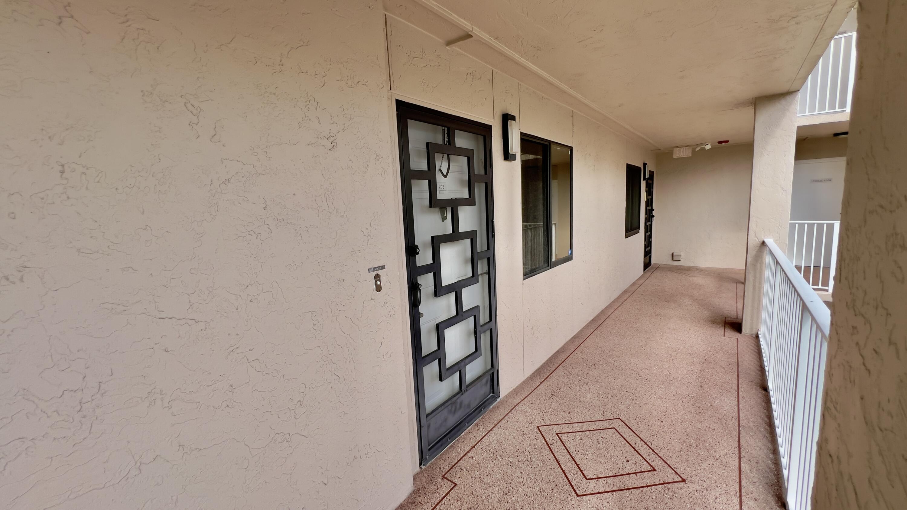 6121 Pointe Regal Circle, Unit 209 Delray Beach, FL 33484 - Photo 2 of 41 a view of a hallway with windows