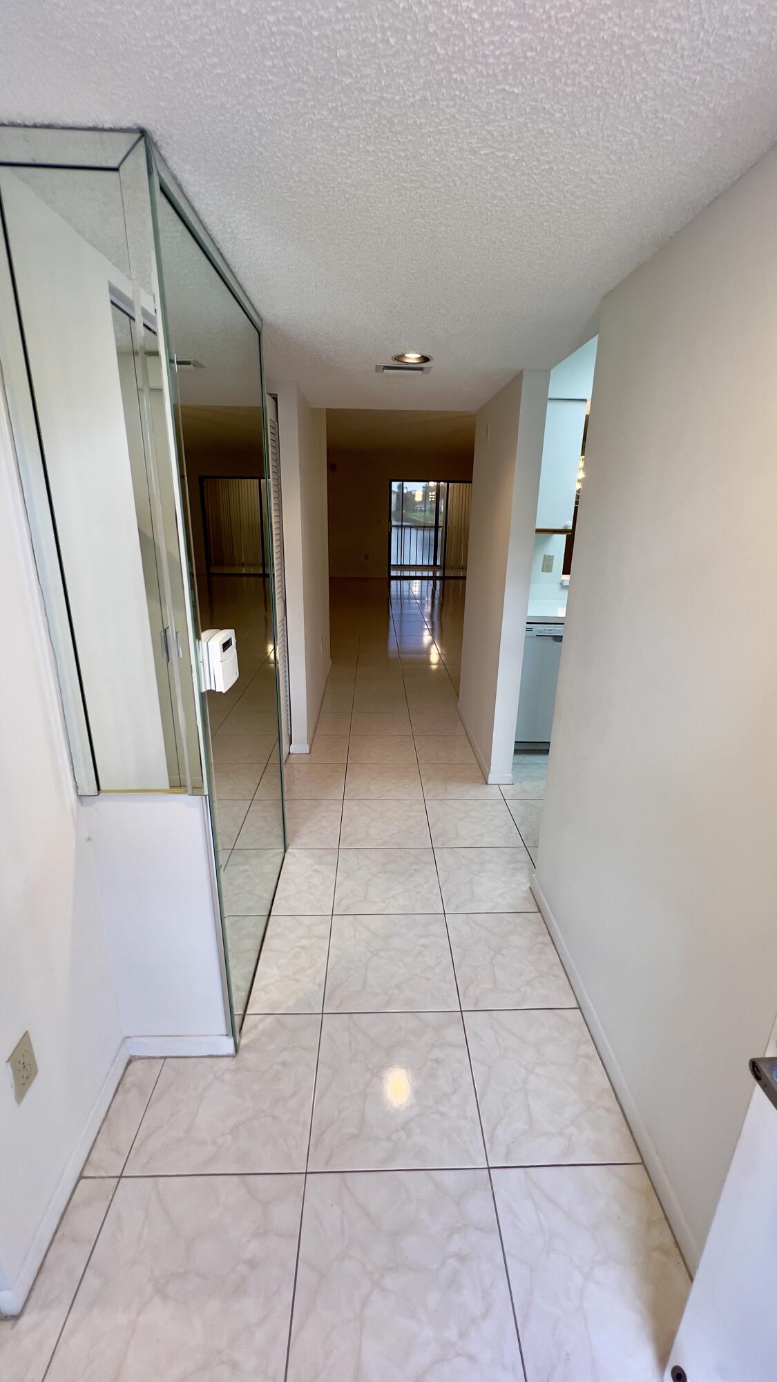 6121 Pointe Regal Circle, Unit 209 Delray Beach, FL 33484 - Photo 3 of 41 a view of a hallway to rooms and stairs