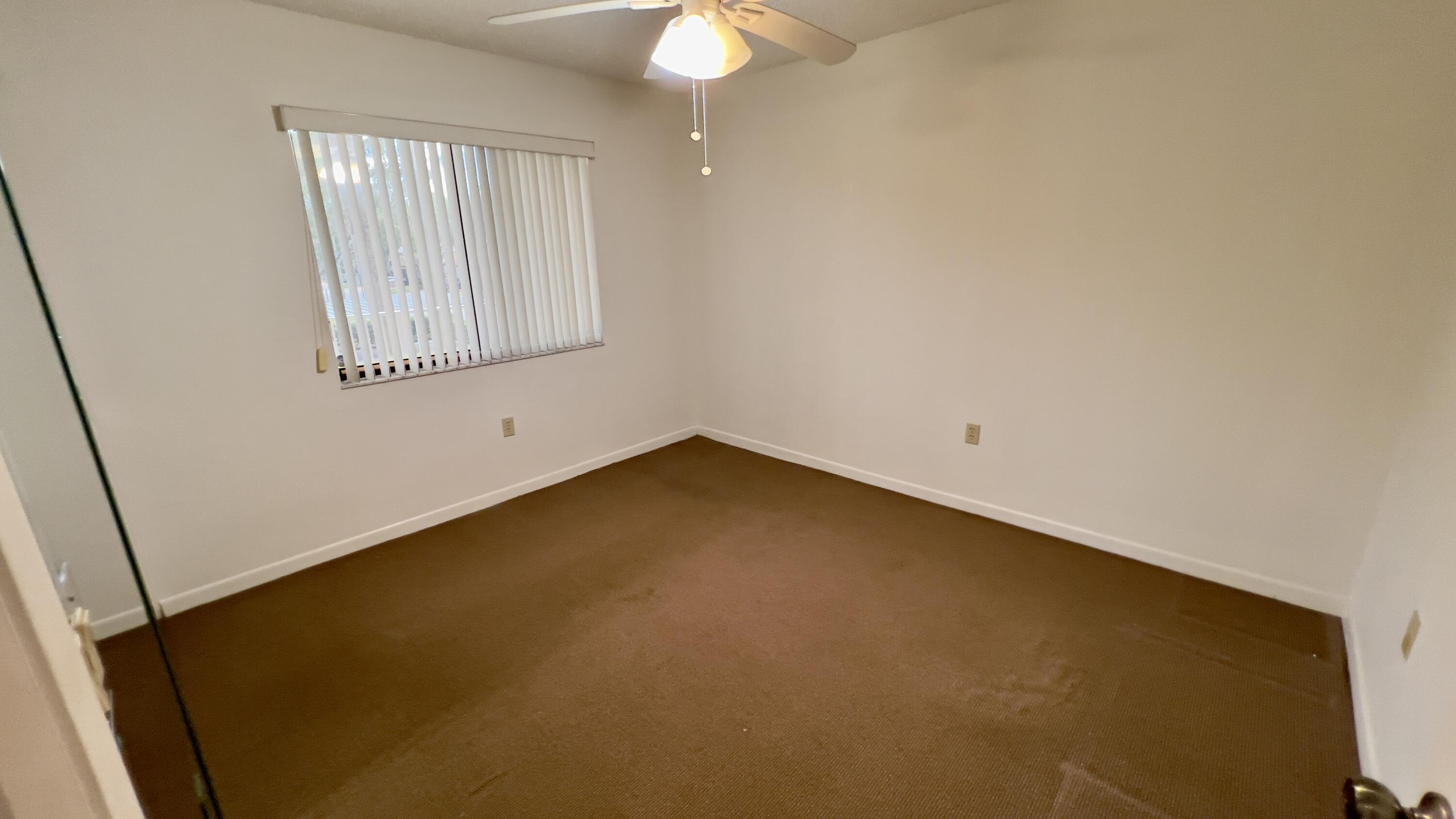 6121 Pointe Regal Circle, Unit 209 Delray Beach, FL 33484 - Photo 10 of 41 an empty room with a window