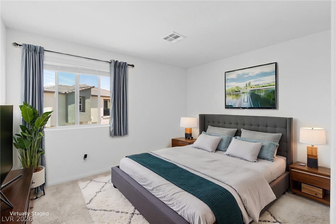 12367 Indigo Montage Road, Unit 3 Las Vegas, NV 89183 - Photo 21 of 33 This serene bedroom offers plush carpeting, a large window, and recessed lighting for comfortable living.